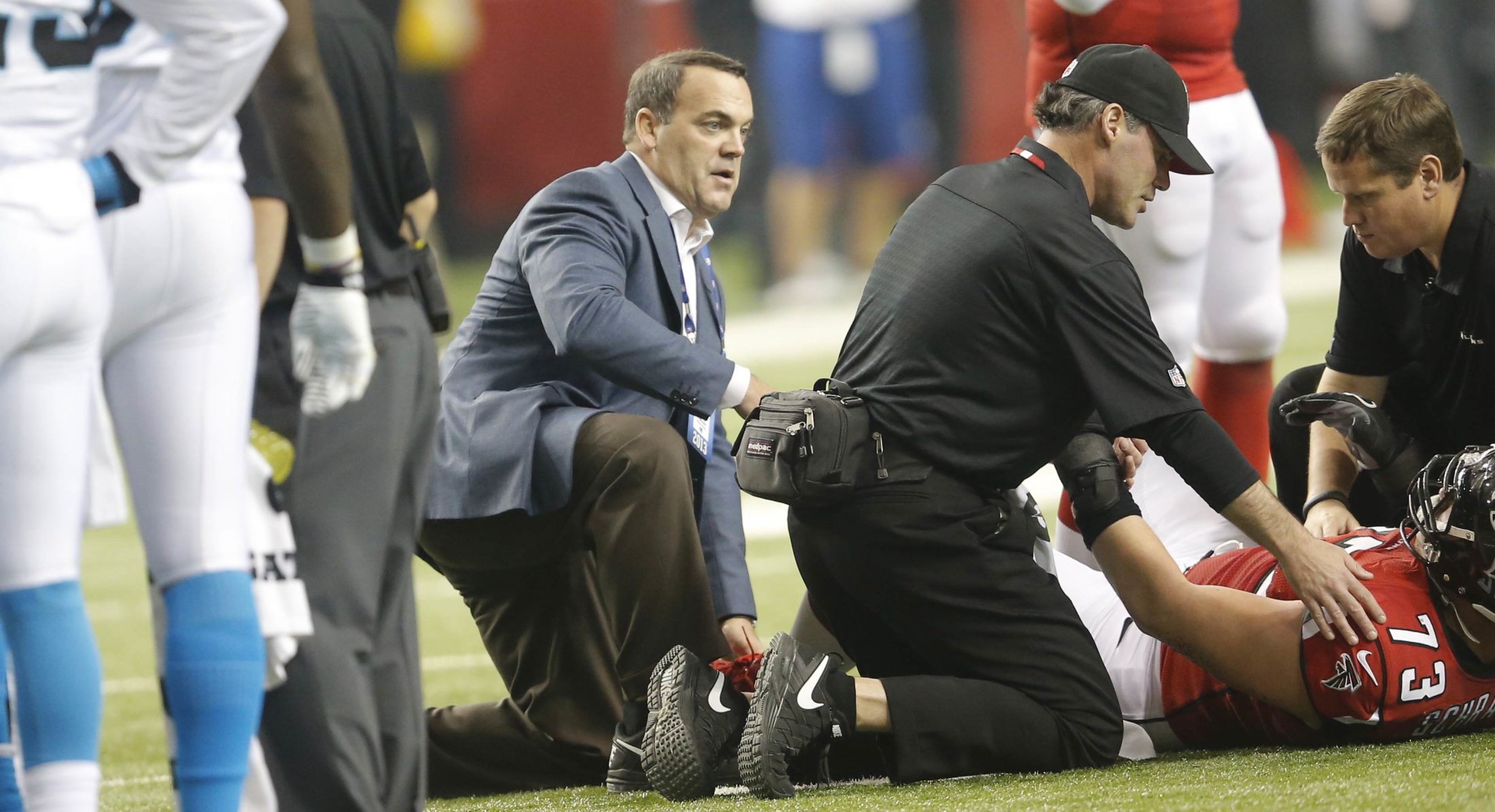Dr. Spero Karas, one of America's top sports medicine specialists on the field with injured Atlanta Falcons player
