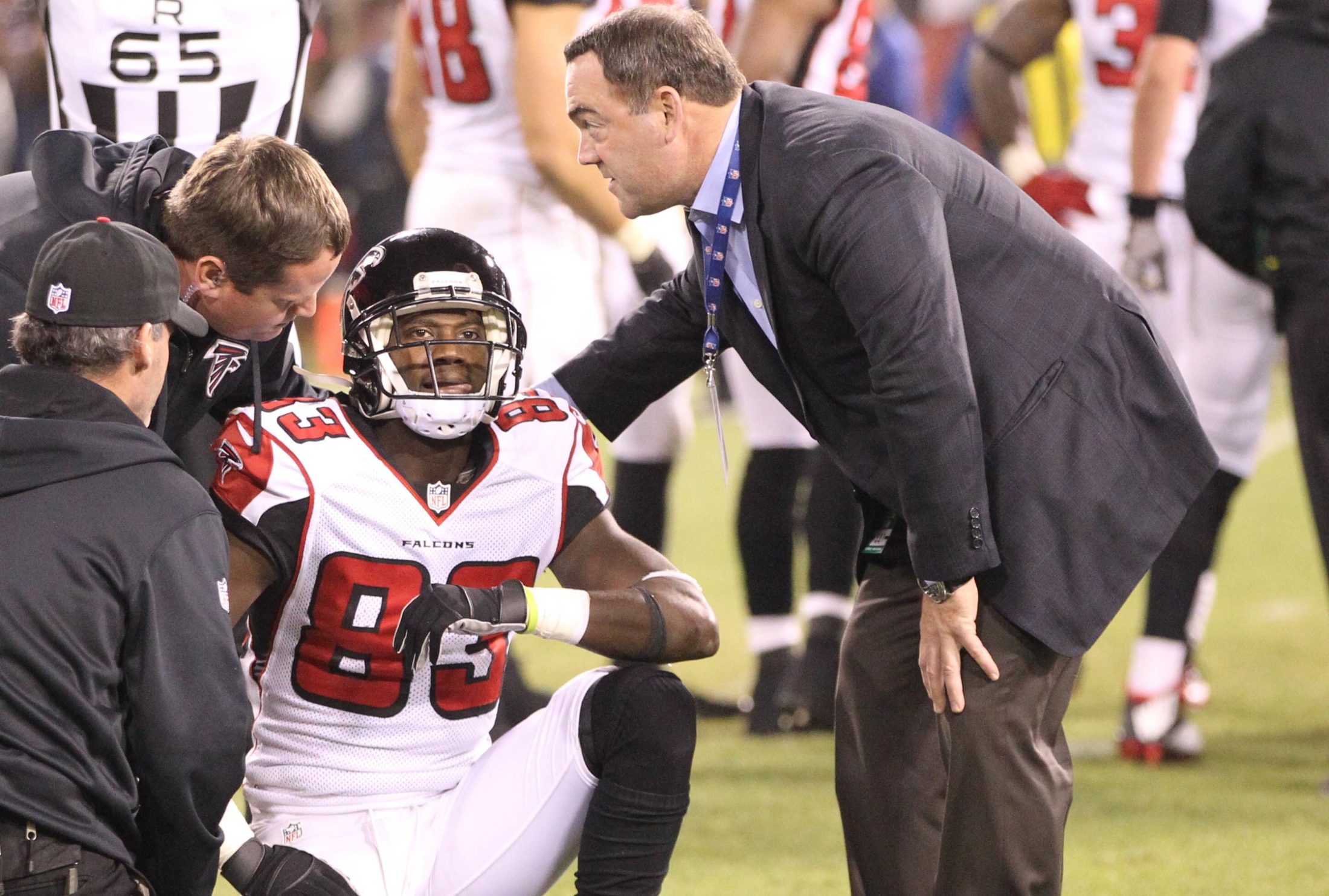 Dr. Spero Karas, head team physician for the Atlanta Falcons on the field with Falcons player